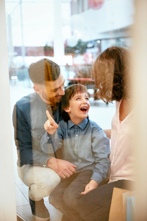 Family In Shopping Mall. Happy People Laughing And Looking Through Store Window. High Resolution.の写真素材