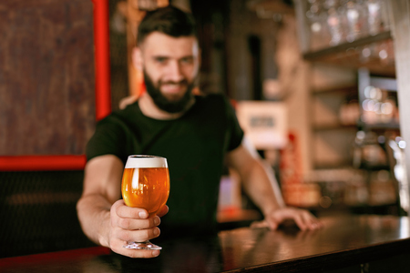 Craft Beer. Man Holding Glass With Beer In Pub, Bartender At Bar Counter. High Resolution.の写真素材