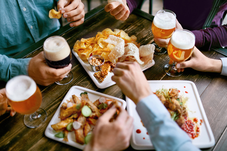 Men Drinking Beer And Eating Snacks, Tasty Food Closeup In Pub Restaurant. High Resolution.の写真素材