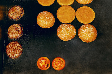 Cooking Burgers. Meat And Buns Roasting On Grill In Restaurant Kitchen. High Resolution.の写真素材