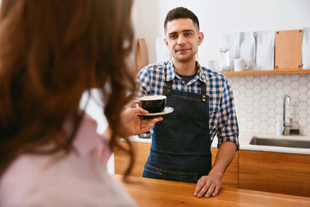 Coffee Shop. Barista Giving Cup Of Coffee To Customer In Cafe. High Resolution.の写真素材