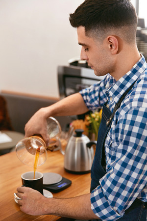 Coffee. Man Making Drink In Cafe, Pouring Hot Fresh Coffee Through Filter. High Resolution.の写真素材