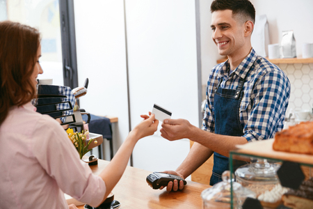 Buy Coffee. Woman Paying With Credit Card In Cafe. High Resolution.の写真素材