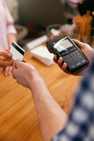 Customer Paying With Credit Card In Coffee Shop Closeup. High Resolution.の写真素材