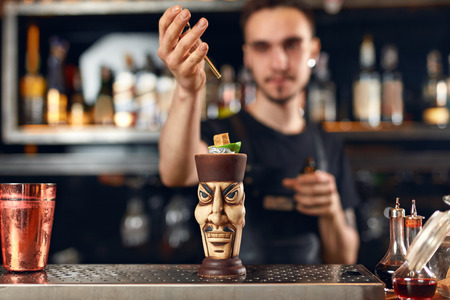 Preparing Cocktails. Bartender Making Tiki Cocktail In Bar, Decorating Drink With Lime And Sugar Cube. High Resolution.の写真素材
