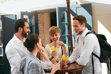 Friends Having Fun, Drinking In Bar Outdoors. Happy Smiling People Drink Cocktails At Street Cafe. High Resolutionの写真素材