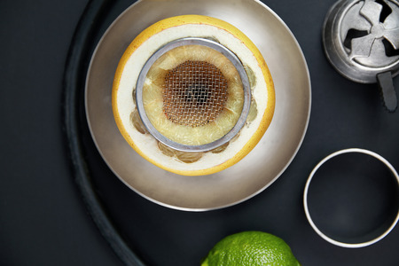 Fruit Shisha Hookah Bowl On Black Background. Orange Citrus Cup With Sieve On Table. High Resolutionの写真素材