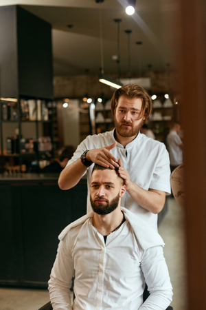 Men Hair Salon. Man Barber Doing Hairstyle In Barbershop. Handsome Male Client And Hairdresser. High Resolutionの写真素材