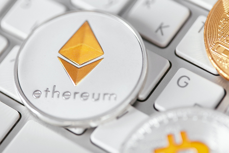 Digital Currency. Cryptocurrency Coins On Computer Close Up. Bitcoin And Ethereum Coins On Computer Keyboard. High Resolutionの写真素材