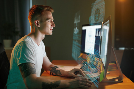 Programmer Coding On Holographic Display. Man Creating App, Programming Software On Computer. High Resolutionの写真素材