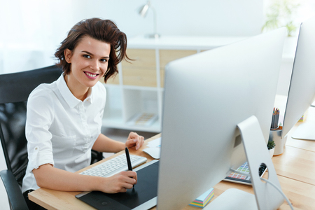 Woman Working On Project On Computer In Office. Female Designer Working On Digital Drawing Tablet. High Resolutionの写真素材