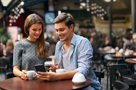 Couple Drinking Coffee On Date In Cafeの写真素材