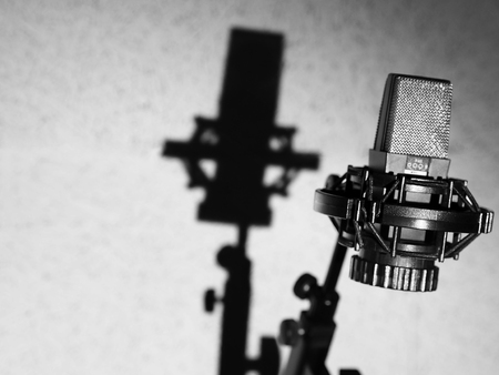Microphone In Studio. Professional Black Sound Recording Microphone In Light On Grey Background. High Resolutionの写真素材