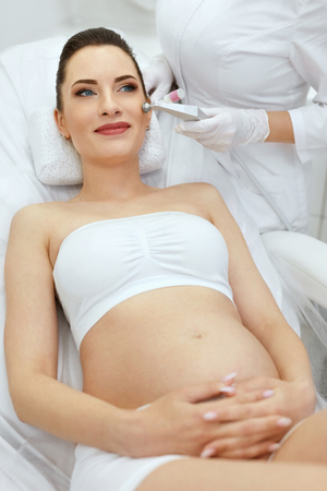 Beauty Treatment. Pregnant Woman Getting Cryo Oxygen Therapy On Facial Skin At Cosmetology Clinic. High Resolutionの写真素材