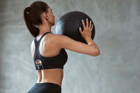 Woman In Fashion Sports Clothes Workout With Med- Ball, Female Training In Black Sport Bra. High Resolutionの写真素材