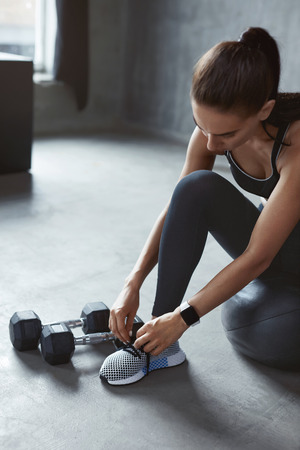 Fashion Sport Shoes. Sports Woman Tying Shoelaces On Sneakers, Female Training In Footwear. High Resolutionの写真素材