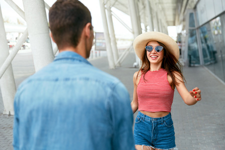 Couple Meeting After Long Time, Running To Each Other Near Airport. People Meeting After Long Parting At Arrival Terminal. High Resolutionの写真素材