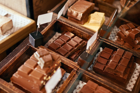 Chocolate Bars In Confectionery Shop Closeup. Handmade Chocolate On Wooden Showcase In Workshop. High Resolutionの写真素材