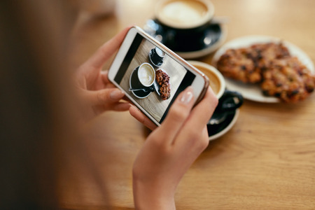 Food Photo On Mobile Phone In Cafe. Woman Hands Making Photos Of Coffee On Smartphone In Restaurant. High Resolutionの写真素材