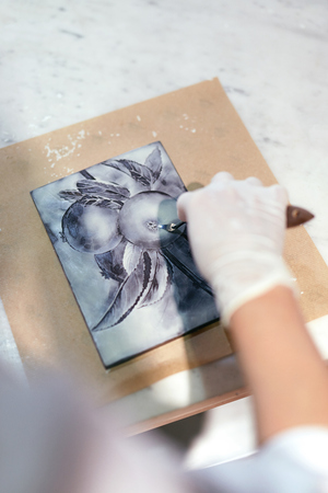 Chocolate Art Work On Chocolate Bar. Confectioner Hands Cutting Picture On Handmade Chocolate. High Resolutionの写真素材