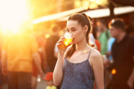 Woman Drinking Beer Outdoors. Attractive Girl With Beer Glass On Festival. High Resolutionの写真素材