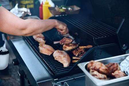 Cooking Meat On Grill Outdoors Close Up. Chef Cooking Barbecue On Street Food Festival. High Resolutionの写真素材
