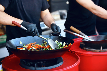 Chef Cooking Thai Dish Closeup At Street Food Festival. Preparing Vegetables In Wok Outdoors. High Resolutionの写真素材