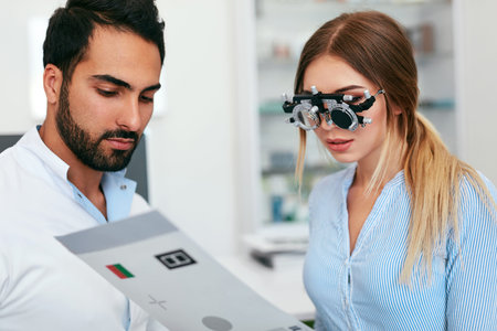Ophthalmology Clinic. Eye Doctor Testing Woman Eyesight, Female In Optometry Glasses. High...