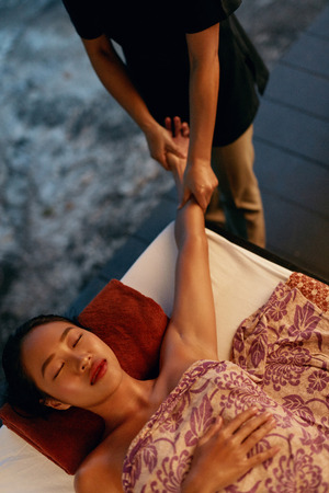 Thai Body Massage. Beautiful Asian Woman Getting Hand Massage At Spa, Relaxing At Resort. High Resolutionの写真素材