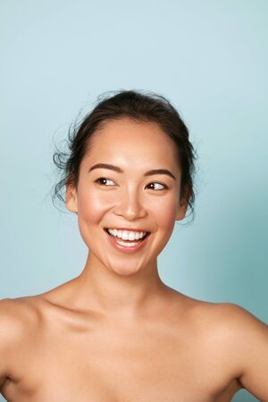 Beauty face. Smiling asian woman with perfect skin, white smileの写真素材