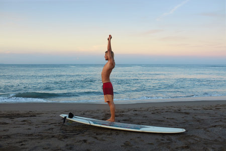 Surfing Man. Stretching Surfer On Sandy Beach Going To Surf On Surfboard. Water Sport For Active...