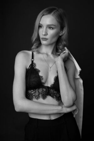 Sexy Lingerie Female Portrait. Fit Curly Woman In Fashionable Black Lace Bra And Cross. Seductive High Fashion Trend.の写真素材