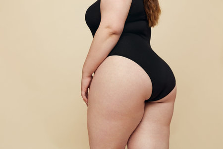 Plus Size Model. Woman Hips Close Up. Fat Torso In Black Bodysuit. Full-figured Female Posing On...