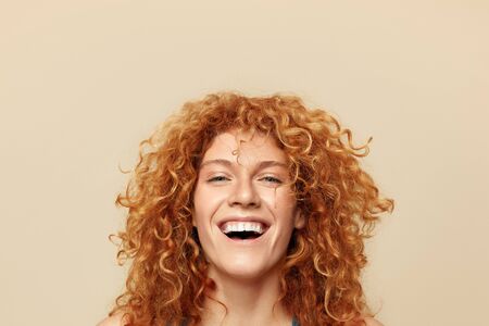 Redhead Woman. Cheerful Girl Close Up Portrait. Beautiful Female With Curly Red Hair Looking At Camera. Face Expression And Natural Emotions.の写真素材