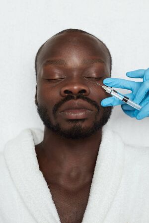 Face Treatment. Male Injection. Man Receives Anti Aging Skin Care. Beauty Cosmetology Procedure In Clinic. Beautician Hands In Gloves With Syringe.の写真素材