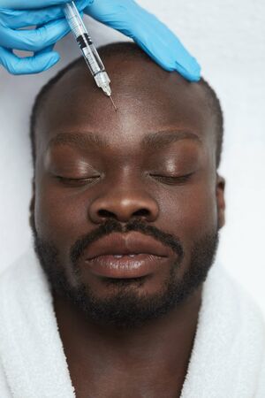 Beauty Injection. Face Skin Care. Man Receives Anti Aging Cosmetology Treatment In Clinic. Beautician Hands In Gloves With Syringe.の写真素材