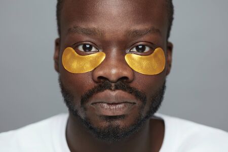 Skincare Beauty Routine. Yellow Under Eye Patches On Male Model. Cosmetic Mask On Face. Cosmetology Facial Treatment.の写真素材