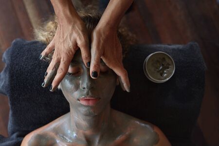 Spa Face Mask. Beauty Treatment For Skin Care. Beautician Massaging Female Face. Relaxed Model On Natural Cosmetic Mud Procedure.の写真素材