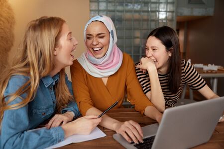 Friends. Women Meeting In Cafe. Three Young Girls With Laptop Working At Bistro. Diversity Female Having Fun In Restaurant. Freelance As Lifestyle.の写真素材