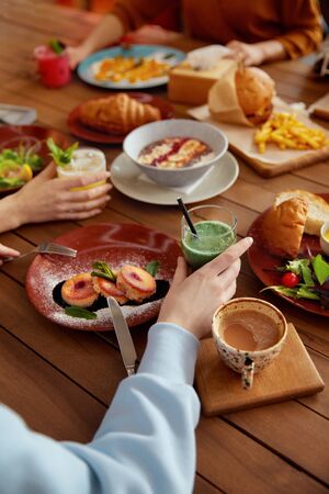 Lunch. Cafe Table With Different Food. Women Eating In Restaurant. Wooden Surface With Colorful Dishes And Drinks. の写真素材