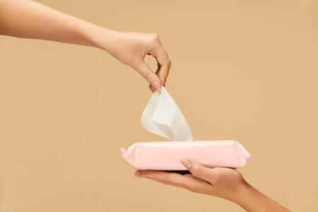 Hand Hygiene. Female Picked Wet Wipes From Pink Pack To Stop Coronavirus. Home And Travel Hygiene For Virus And Bacterial Infection Prevention.の写真素材