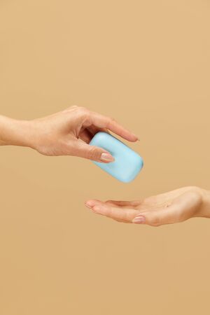 Hands Hygiene. Soap Bar In Female Palm On Beige Background. Daily Personal Washing Routine As Coronavirus And Bacterial Infection Prevention.の写真素材