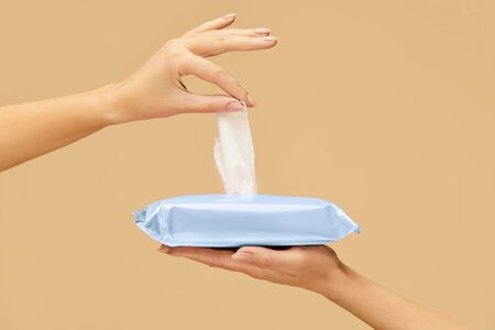 Hygiene. Hand Picking Wet Wipes From Blue Pack To Stop Spreading Of COVID. Daily Hygiene Routine For Virus And Bacterial Infection Prevention.の写真素材