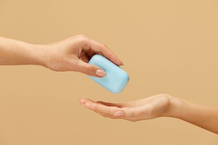Hygiene. Soap Bar In Female Hand On Beige Background. Daily Personal Hygiene Routine As COVID-19 And Bacterial Infection Prevention. Washing Hands For Saving Life.の写真素材