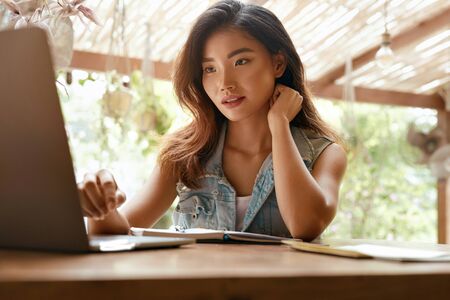 Work At Cafe. Woman With Laptop Working Remotely On Summer Vacation At Tropical Country.の写真素材