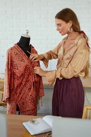 Job. Fashion Designer At Workshop. Beautiful Tailor Creating Summer Dress On Mannequin. Success Self Employed Woman In Stylish Clothes. Professional Dressmaker Working At Own Atelier.の写真素材