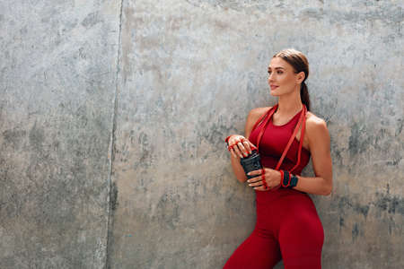 Sport. Woman Stretching On Yoga Mat Before Workout. Fitness Girl With Strong Muscular Body In Fashion Sportswear Doing Twisting Exercise At Outdoor Stadium. Urban Lifestyle And Active People.の写真素材