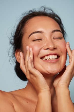Skin care. Woman with beauty face touching facial skin portraitの写真素材