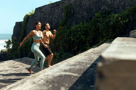 Sport. Couple On Stairs Doing Leg Exercise. Handsome Man And Sexy Woman In Fashion Sporty Outfit Training. Partner Workout Outdoor On Summer Vacation As Lifestyle.の写真素材
