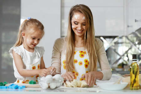 Family Cooking. Woman With Child Baking At Homeの写真素材